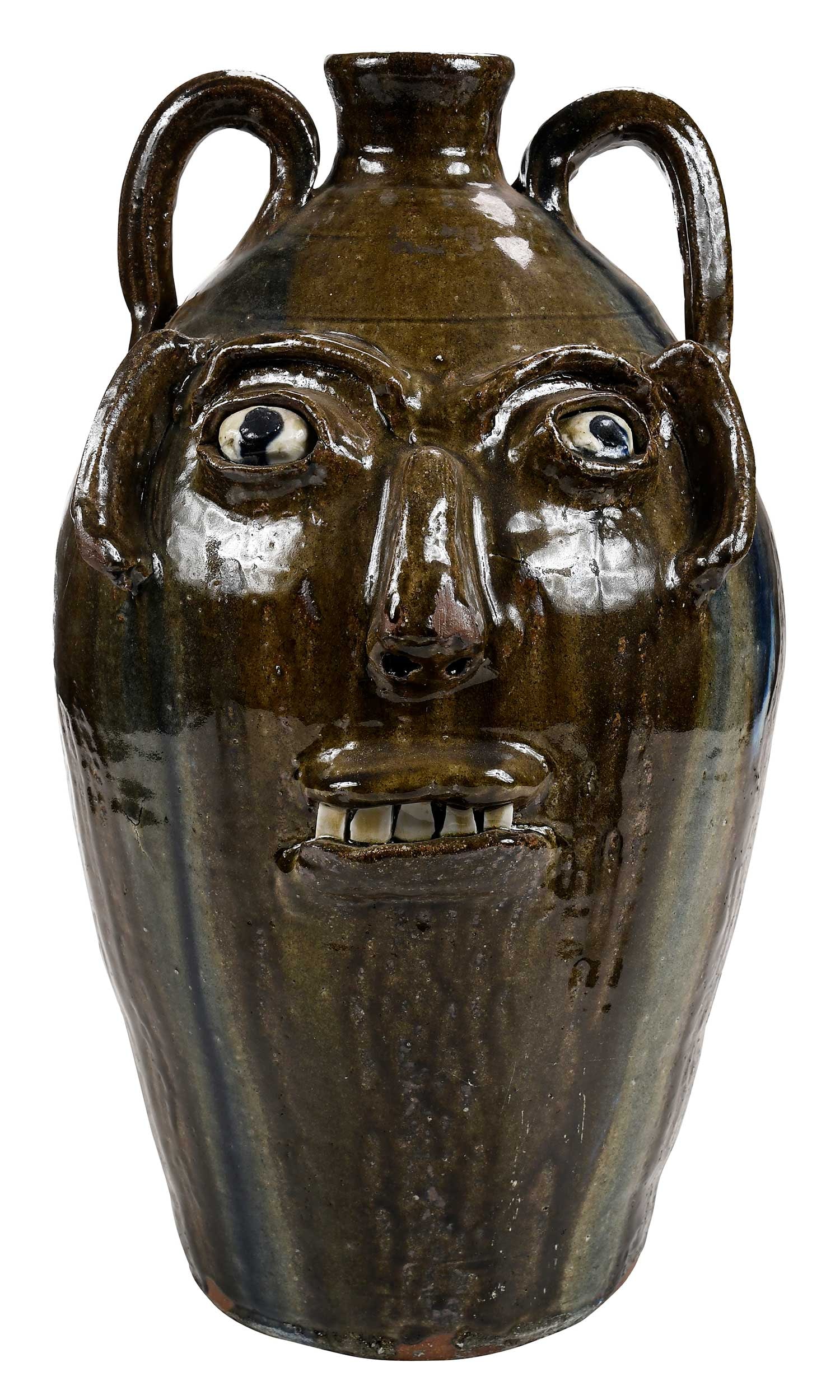 Large Signed Burlon Craig Face Jug: (Vale, North Carolina, 1914-2002) light and dark olive green runny alkaline glaze, cobalt blue melt runs down entire sides of jug from handles with cream highlights, applied facial features, broken ch