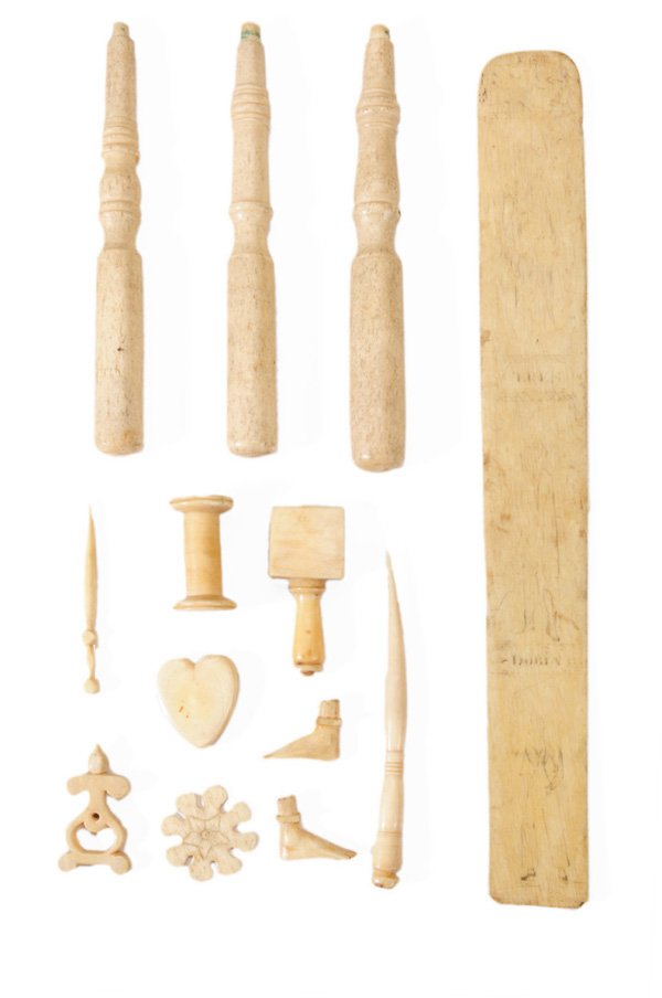 Large Assortment of Carved and Turned: Whale Bone Scrimshaw Elements including numerous handles, two carved feet, small shuttles, several uncarved teeth, other implements and parts, (approximately 84 pieces) Provenance: By descent in the D