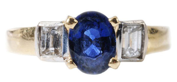 Sapphire, Diamond Ring: oval faceted cut 1.44 ct. sapphire with two channel-set rectangular step-cut diamonds, estimated combined diamond weight .40 cts., color H-I, clarity VS, 18 kt. two-tone gold mount, gross weight 6.1 g