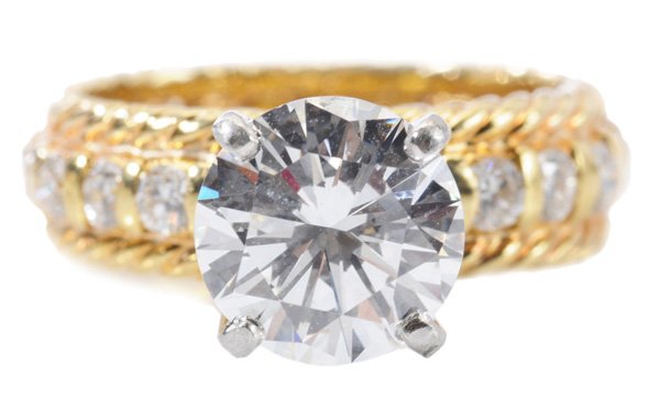 Diamond, 18 Kt. Gold Ring: one round 2.10 ct. brilliant-cut diamond, color H-J, clarity VS2, set in 18 kt. eternity band containing 22 bar-set round full-cut melee of diamonds bordered by twisted wire shoulders, combined melee 