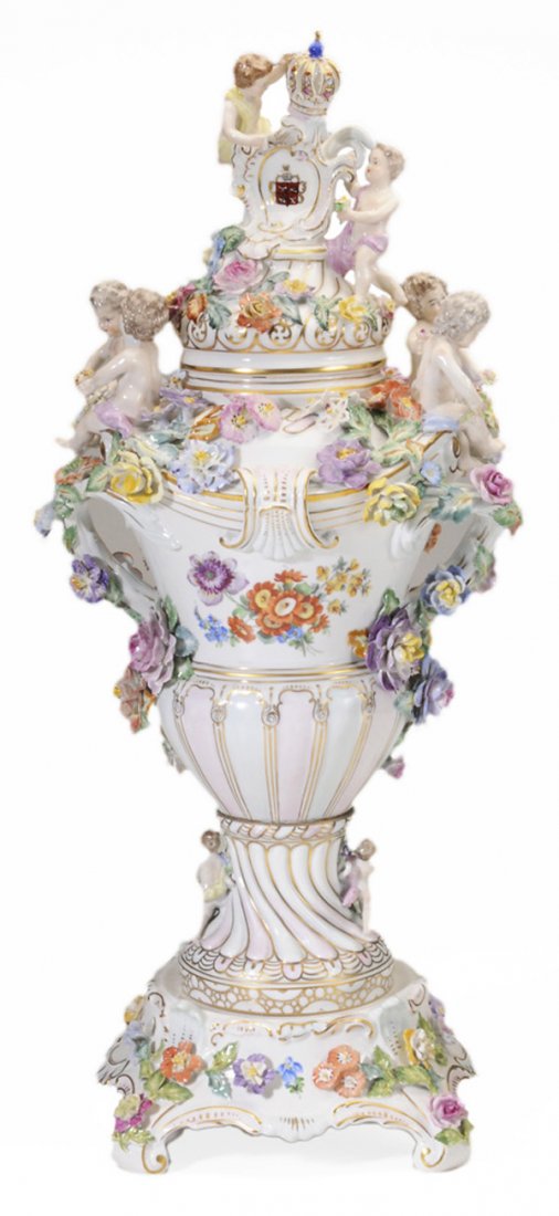 Large Dresden Figural Porcelain Lidded: Urn on Stand 20th century, elaborately decorated with [putti] and floral ornament, crown finial, blue Dresden mark, on stand, 28-3/4 in., good condition overall, chip and loss at one corner of base Pr