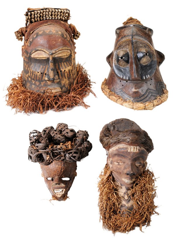 Four Carved and Polychromed: Tribal Masks Africa, 20th century, Kuba, Pende, and other cultures, one with cowrie shell mounts, one with metal mounts, all retaining some plant fiber appliques, 7 to 14 in., all with surface wear an