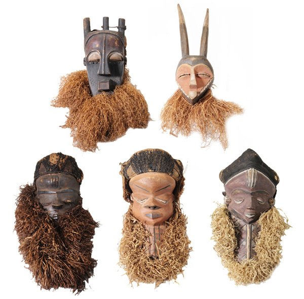 Five Carved and Polychromed: Tribal Masks, Africa, 20th century, Kuba, Pende, and other cultures, with plant fiber and/or fabric appliques, 7 to 20 in., generally good condition, surface wear and losses, wear and deterioration wi