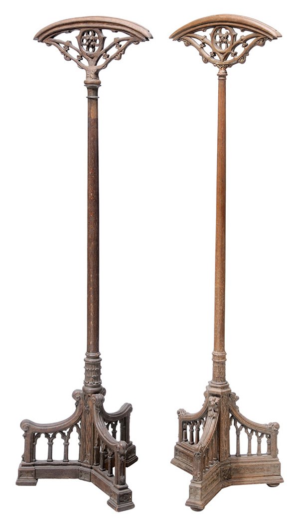 Two Similar Gothic Style Vestment: Stands British or Continental, late 19th/early 20th century, carved oak, 56-1/4 in., one top currently detached, the other probably restored, other surface wear and restorations Provenance: One with S