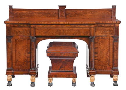 New York Classical Parcel Gilt and Paint Decorated Mahogany Sideboard and Cellarette: early 19th century, possibly Duncan Phyfe or contemporary, figured backsplash flanked by reeded pilasters, breakfront top with return slides over three conforming drawers, paneled cabinet doors and fo