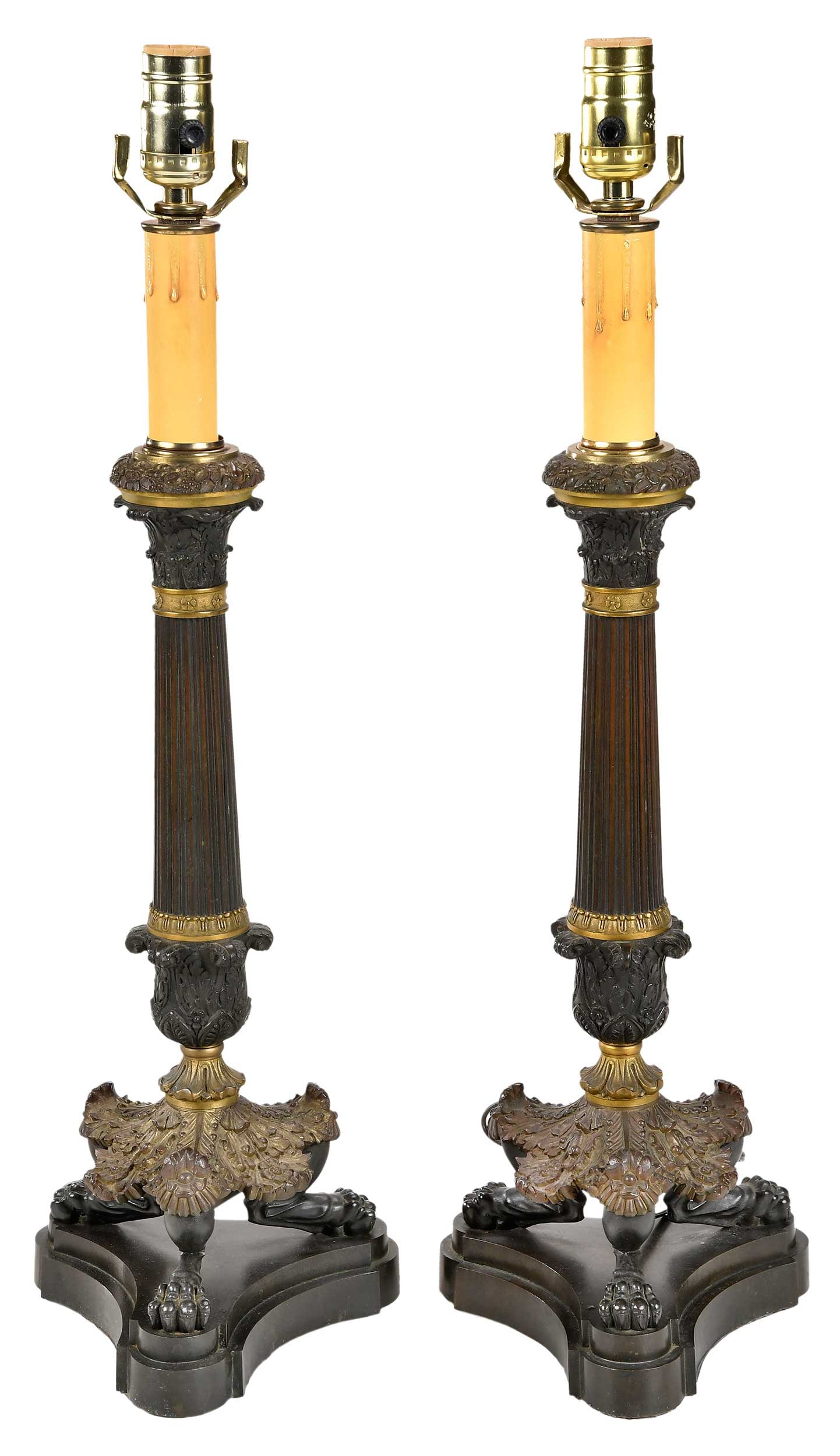 Pair of French Empire Style Column Form Lamps: 20th century, each with Corinthian column form shaft with paw feet on trifid base, 25 in. to socket; with two painted shades and associated harps, 12-1/4 x 17-1/4 in. Provenance: Property from the Col