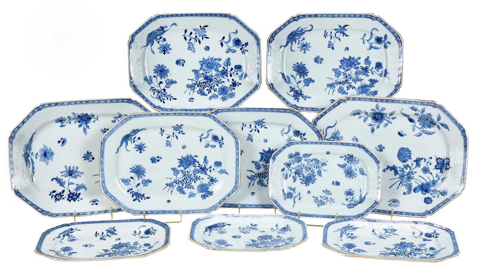 Ten Chinese Blue and White Porcelain Dishes: Qing dynasty, Qianlong period, each finely painted with composite floral sprays including hibiscus, rose, orchid, and peony, within a diaper-pattern band at the rim, graduating sizes from 10 x 7-3/8 i