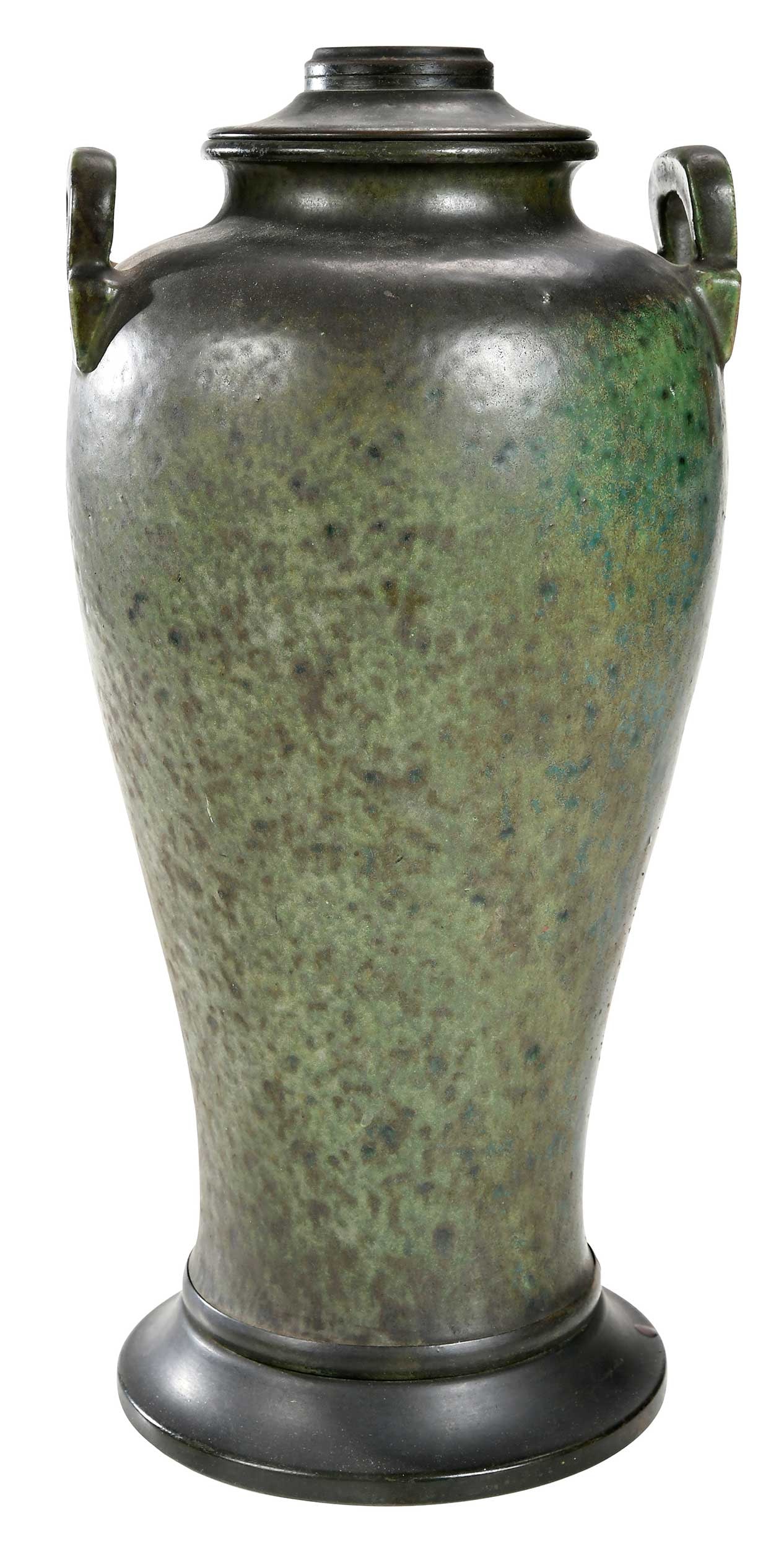 Ceramic Arts and Crafts Oil Lamp Base: 20th century, in spotted green glaze, with two handles at shoulder, brass oil basin and foot, 16-3/4 x 7-7/8 in. Provenance: The Collection of Clare and Jared Edwards, West Hartford, Connecticut