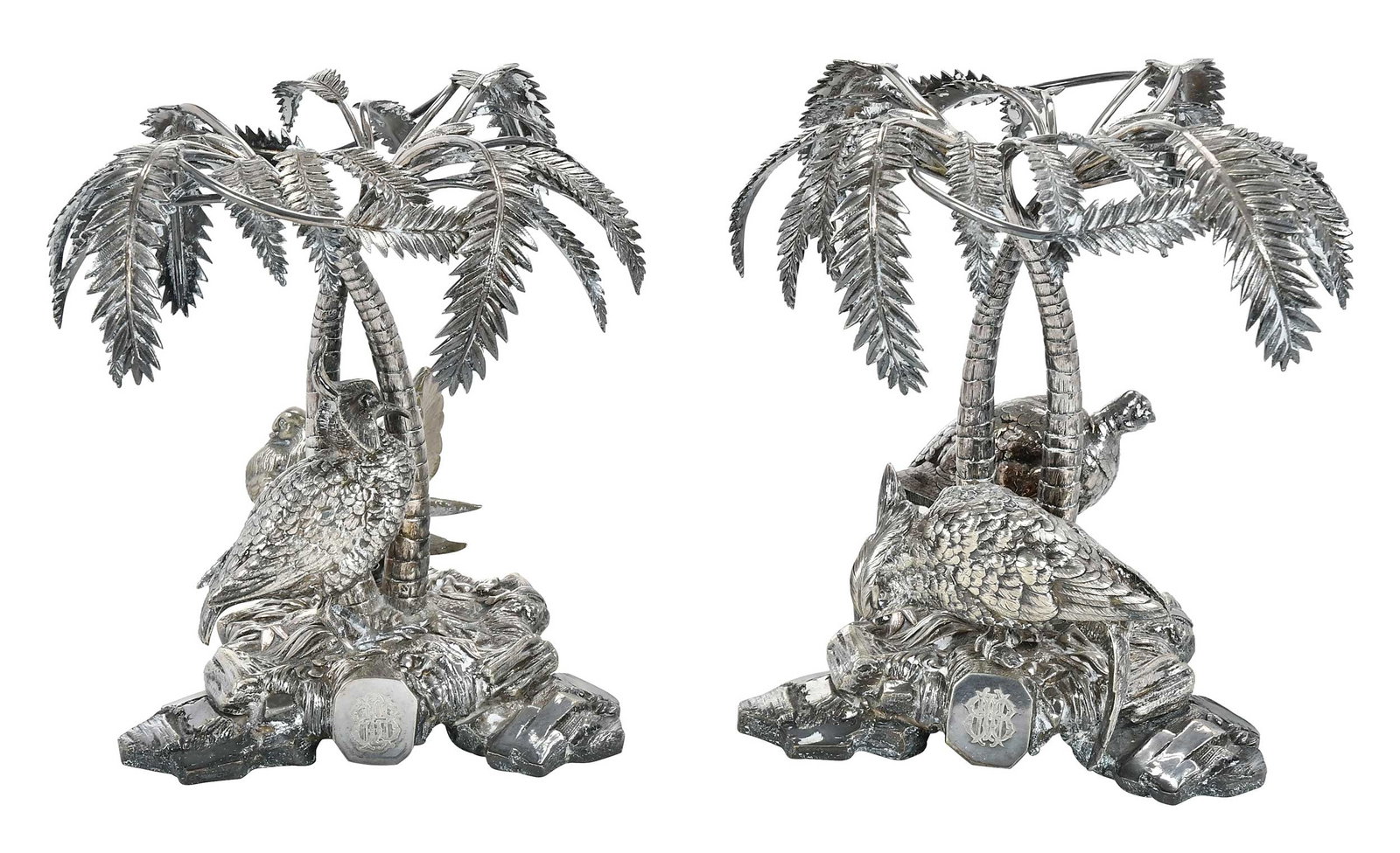 Elkington Silver Plate Stands: English, late 19th century, rocky form bases with palm trees and fowl, marks for Elkington, 7-3/4 x 7-1/4 x 8-1/4 in. Provenance: The Collection of Clare and Jared Edwards, West Hartford, Connecticut