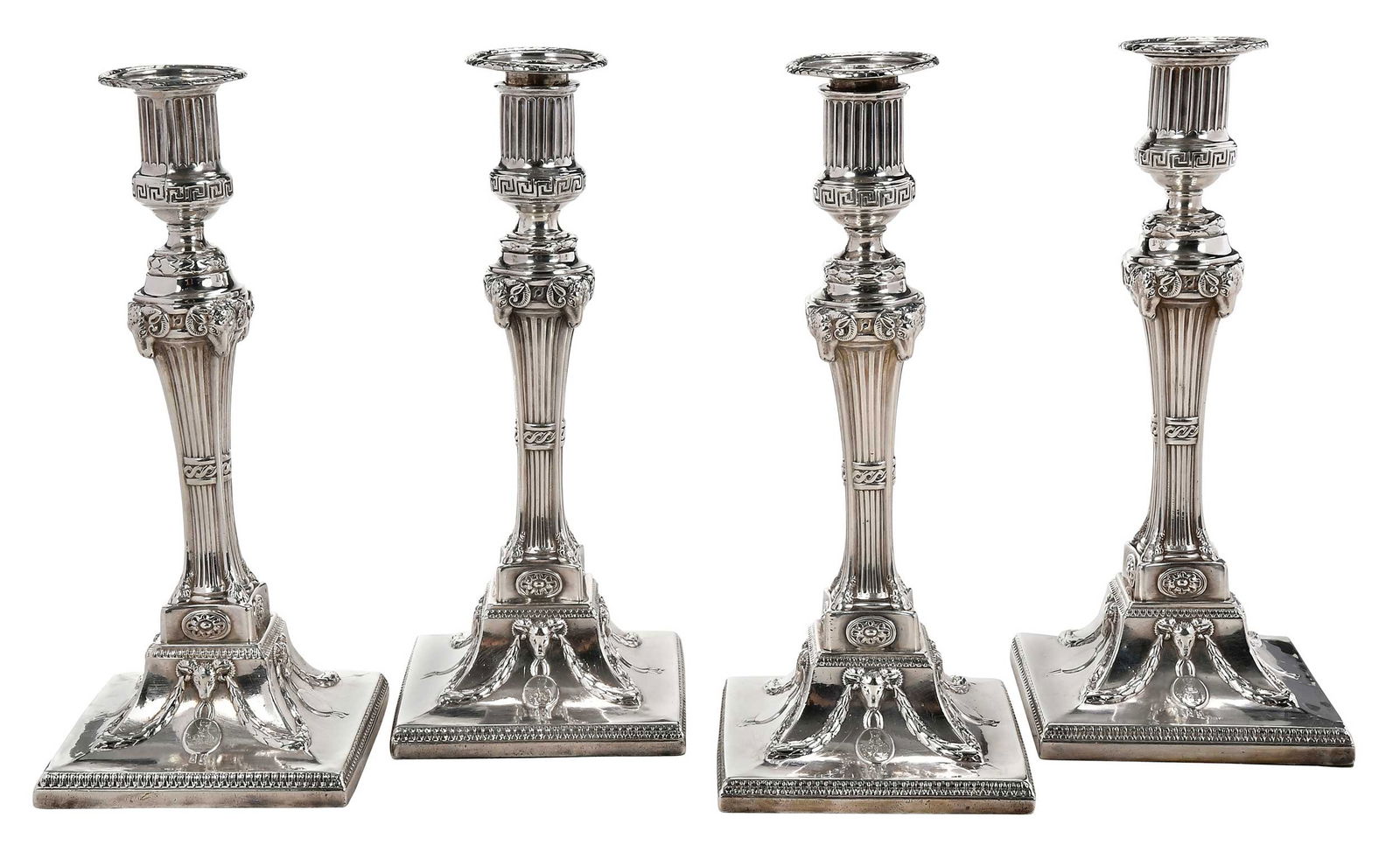 Set of Four George III English Silver Candlesticks: London, 1773, urn sockets with Greek key border, tapering post with ram's head corners and ending in hooves, swag and ram bases, weighted bases, heraldic devices with elephants and tower on base and b