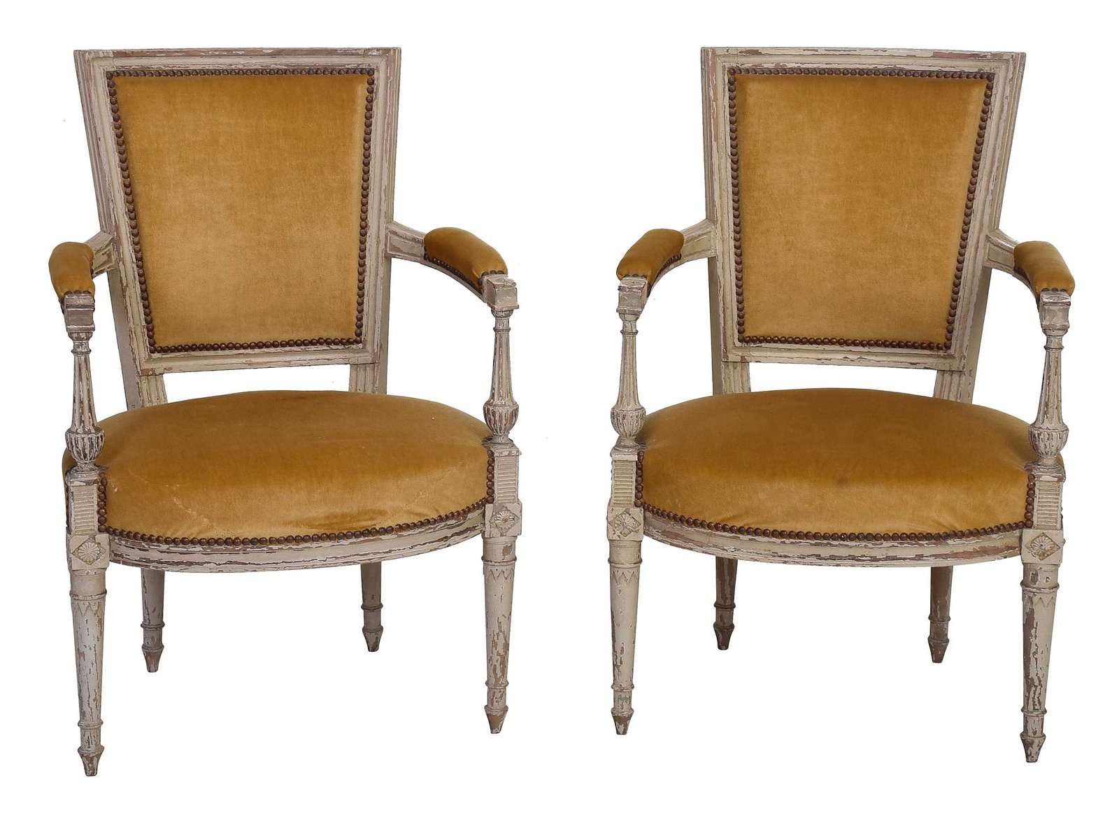 Pair Of Directoire Carved and Painted Walnut Armchairs: French, 19th century, each well carved frame with white paint over earlier pale green, gold velvet upholstery, 31-1/2 x 22-1/2 x 19 in. Provenance: Collection from a French family Chateau, by descent 