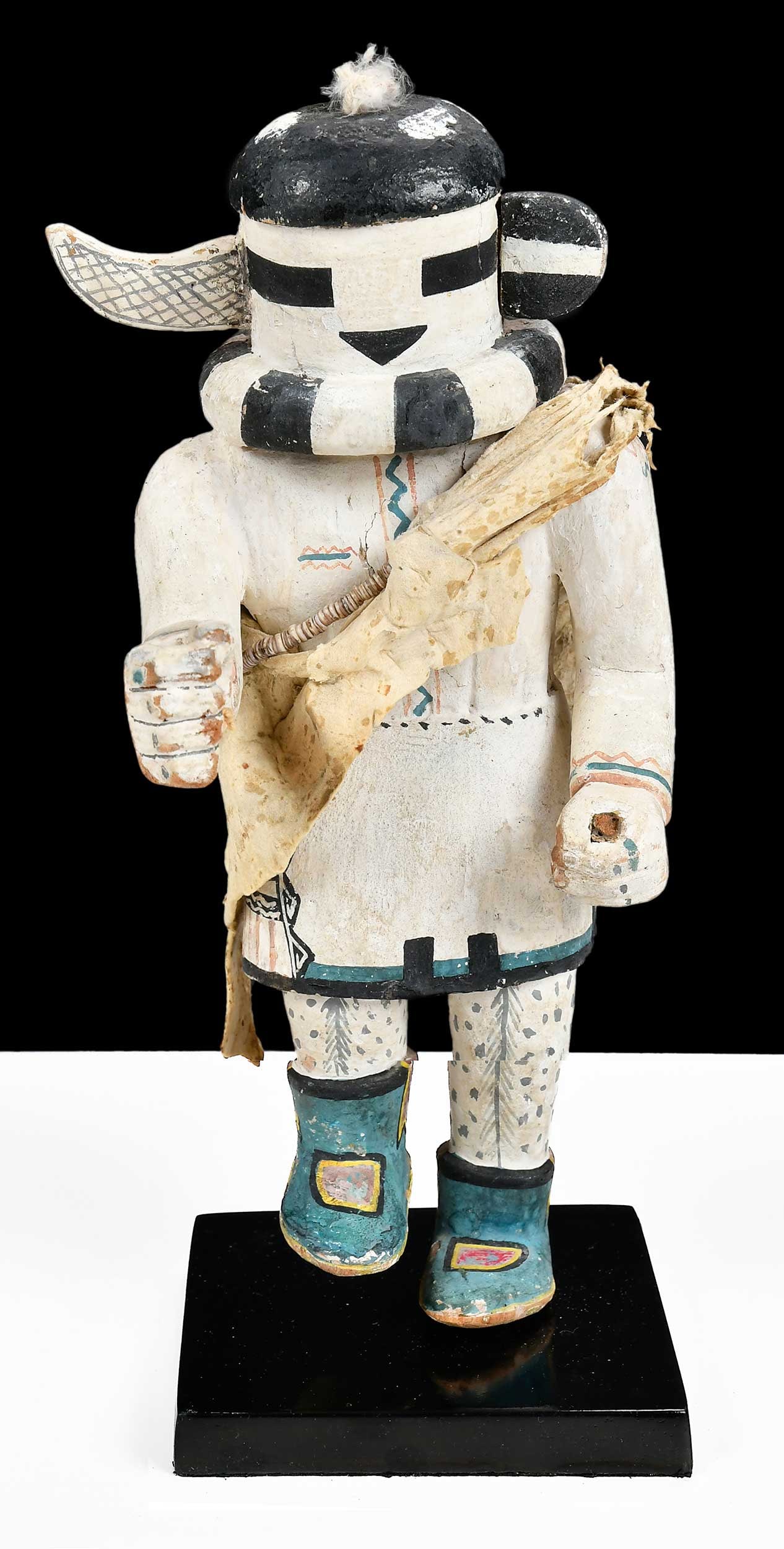 One Horn Kachina: circa 1950s, carved polychrome cottonwood Saiastasana kachina, with hide sash and quiver, tiny cowrie bead necklace, on later attached base, 11-1/4 in. overall. Provenance: Collection of Mark Blackbur