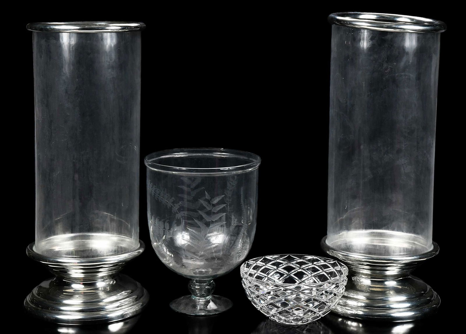 Four Large Glass Decorative Objects including Tiffany: 20th century, comprising: pair of large glass shades on tiered chrome stands, with rounded chrome rims, marked on bases "Rita Jordens/Etain 95%", 27-1/4 x 11-3/4 in. diameter; large hurricane footed v