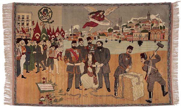 Hand-Woven Pictorial Rug: Turkish, early 20th century, finely woven with soldiers and citizens assembled in urban landscape, Turkish flags, soldiers breaking chain of several prisoners, small cartouche [Viva la Constitution,]