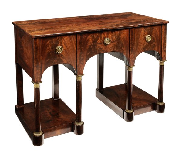 Empire Figured Mahogany Writing Desk: probably French, 19th century, highly figured book-matched veneers, dovetailed drawers with mahogany linings, column-form supports with ormolu capitals and bases, one top edge of drawer with stamped s