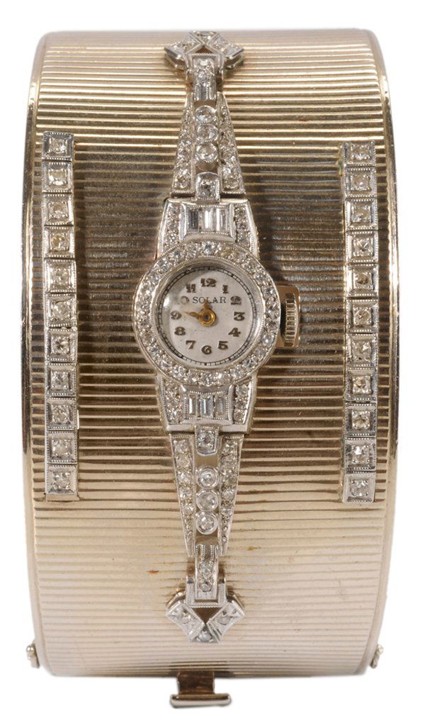 14 Kt. Cuff Bracelet Inset With Watch: lady's vintage (stamped) 14 kt. white gold hinged cuff bracelet with vertical ribbed pattern, inset white gold wristwatch marked "Solar" on dial, watch case marked "900 Plat, 100 Irid", 17-jewel Swiss