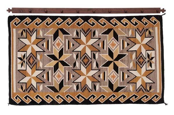 Two Gray Hills Navajo Throw Rug: mid 20th century, 100-1/4 x 56-3/4 in., with hand-crafted teakwood wall hanger, very good condition