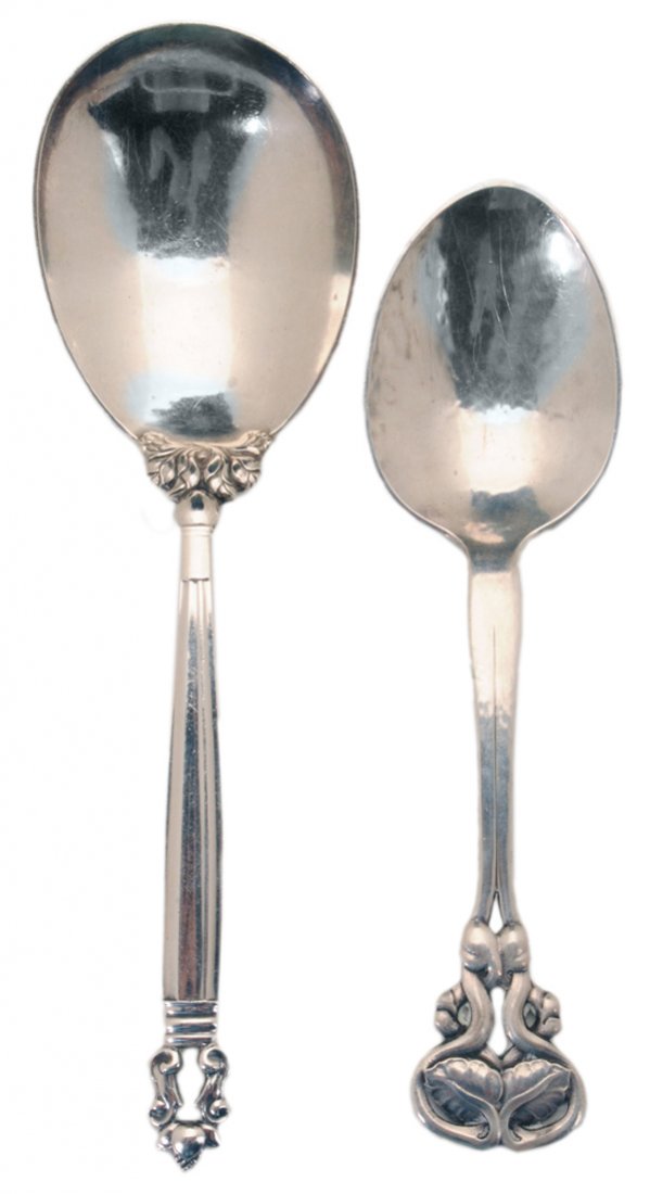 Two Georg Jensen Sterling Serving: Spoons Denmark, 1915-1927: one Pattern No. 58, monogram on back, 7-5/8 in.; one Acorn pattern, no monogram, 8-7/8 in., 5.70 oz.T.; with Georg Jensen bags, good condition, light scratches Provenance: P
