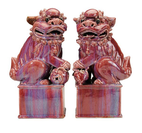 Pair Purple-Glazed Seated Foo Dogs: Chinese, probably 20th century, one seated figure with left paw on pup, the other with right paw on ball, both on raised rectangular platform supports with molded edges, glaze with blue runny striatio