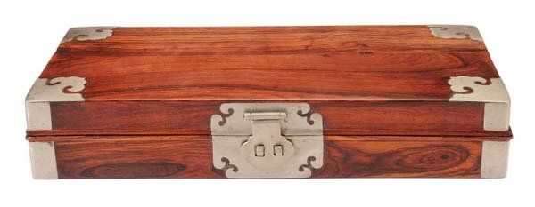 Huanghuali Box: Chinese, late 19th/20th century, possibly Huanghuali with white metal escutcheon and corner mount inlay, 2 x 10-7/8 x 5-1/4 in., minor scratches on top Provenance: Private Collection