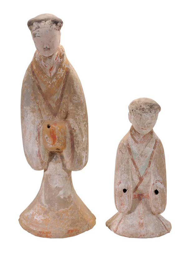 Two Pottery Figures: Chinese, Han Dynasty (BC 206-AD 200), both with remnants of pigment: one figure standing with hands clasped within sleeves, an opening for an implement through the sleeves, 4-1/8 in. slot verso, 29-3/
