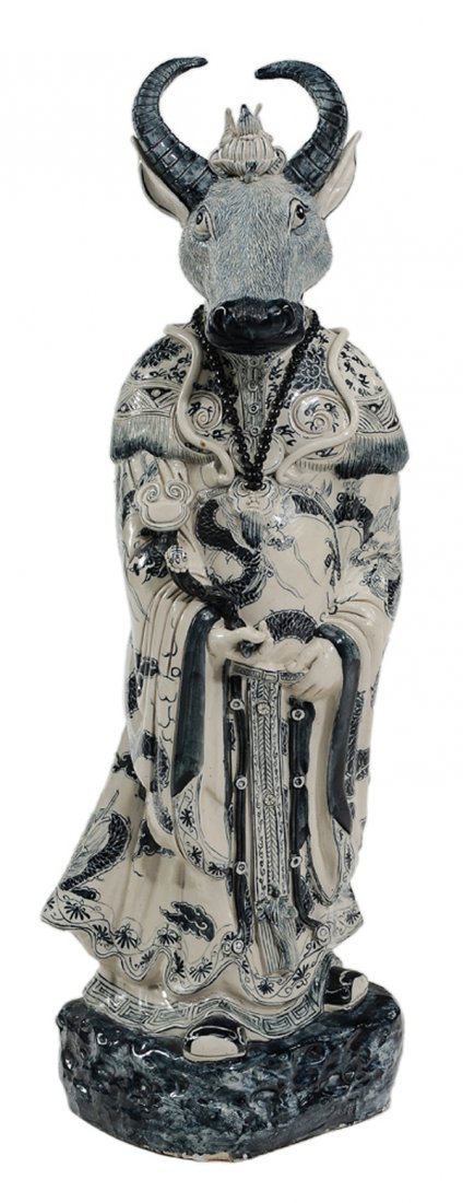 Blue and White Standing Figure of Ox: Head Chinese, 20th century, the mythical figure of Ox Head, holding a scepter and wearing elaborate robes with jewels and badges, on blue rocky crag, 34 x 10-1/4 in., good condition Provenance: Privat