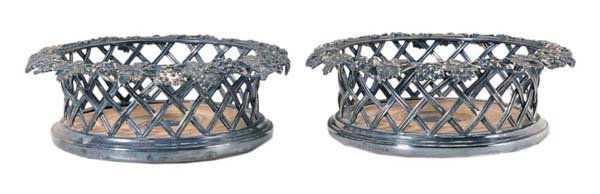 Pair Silver-Plated Wine Coasters: English, 20th century, basketweave sides, grape and vine border, wooden bases, marks for Elkington & Co., no monograms, 2-1/4 x 6-3/4 in., loss to plate, wear Provenance: Estate of the Late Emily Rave