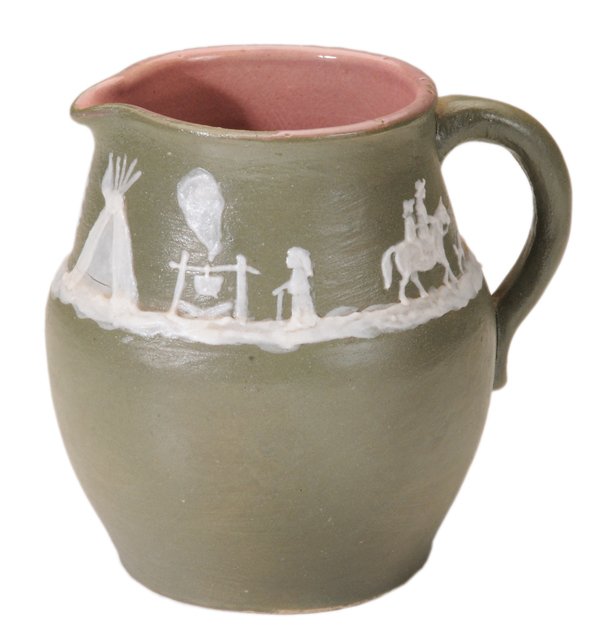 W.B. Stephen Cameo Pitcher: (Walter B. Stephen, Tennessee/North Carolina, 1876-1961), Westward Ho cameo scene with teepee and riders on horseback on matte green ground, marked in cameo "Stephen", impressed Pisgah Forest mark, 19
