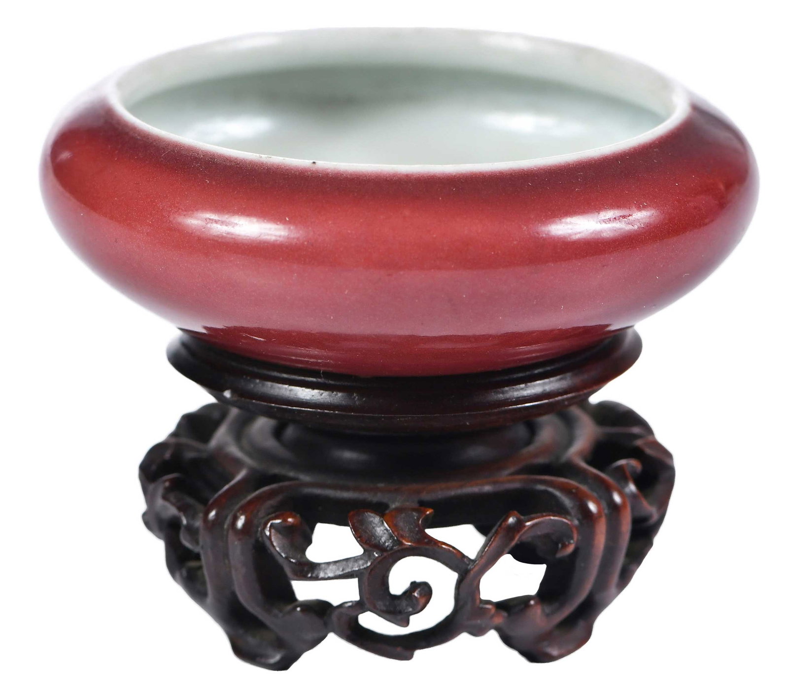 Chinese Oxblood Miniature Water Coupe: oxblood low bowl with white interior glaze, outer glaze in oxblood, 1 x 2-1/2 x 2-1/2 in.; on wood stand, 1 x 2 x 2 in. Provenance: Dr. Stanley Sherman Burns, St. Louis, Missouri; by descent