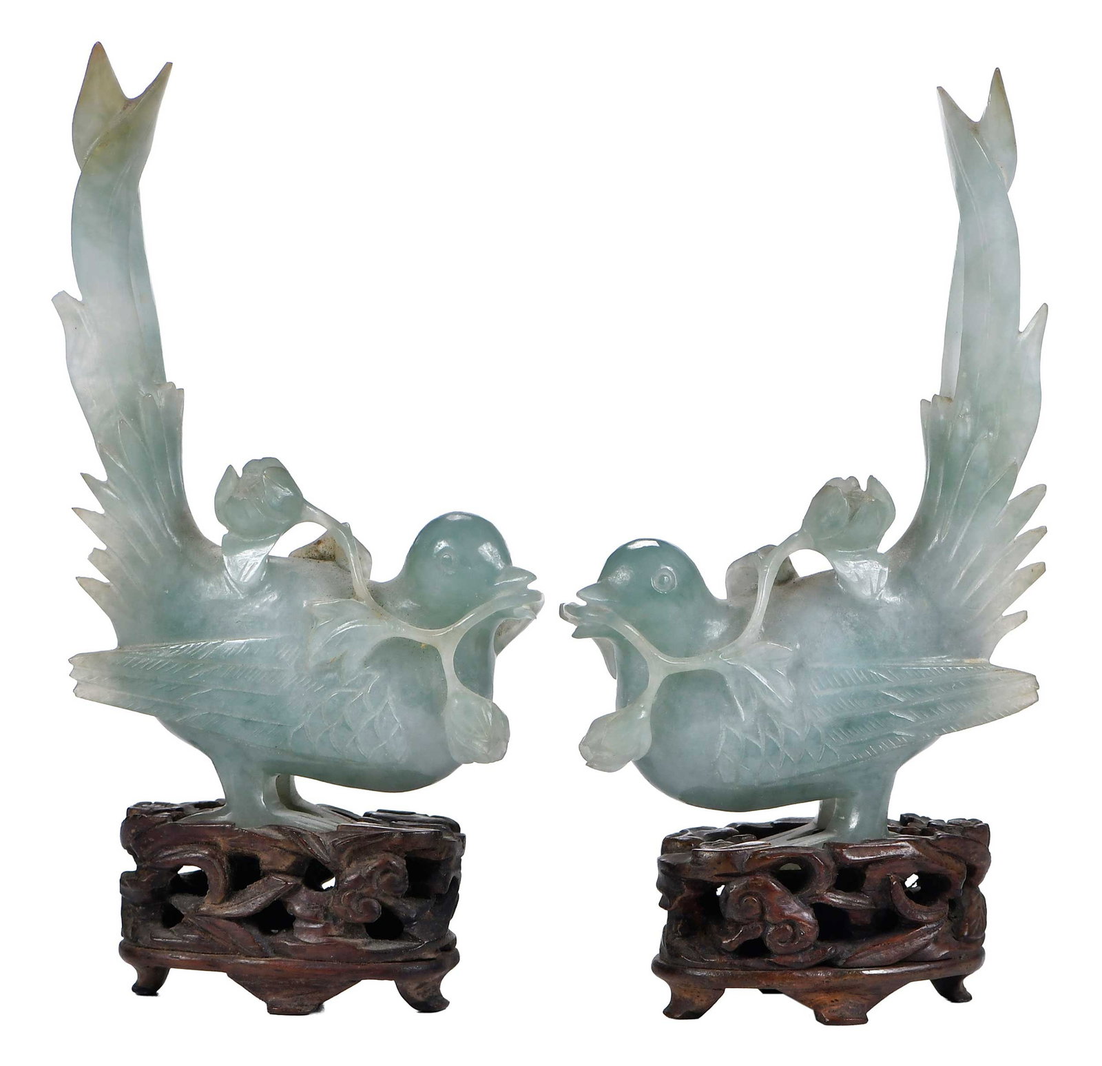 Pair of Chinese Carved Jade Pheasants on Stands: carved pheasants with raised tails, carrying branches in beaks, celadon green with whitish inclusions, 4-1/4 in., height on stand 5 in. Provenance: Collection of Isabel Johnston, Macon, Georgia, and P