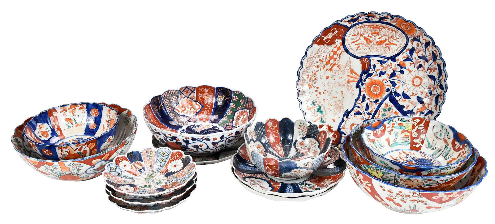 14 Pieces of Imari Scallop Rimmed Porcelain: comprising: three similar bowls, garden scenes on exterior and interior border, centering on scene of flower arrangement, diapering at base, largest 3-3/4 x 9-7/8 x 9-7/8 in.; one platter with landsca