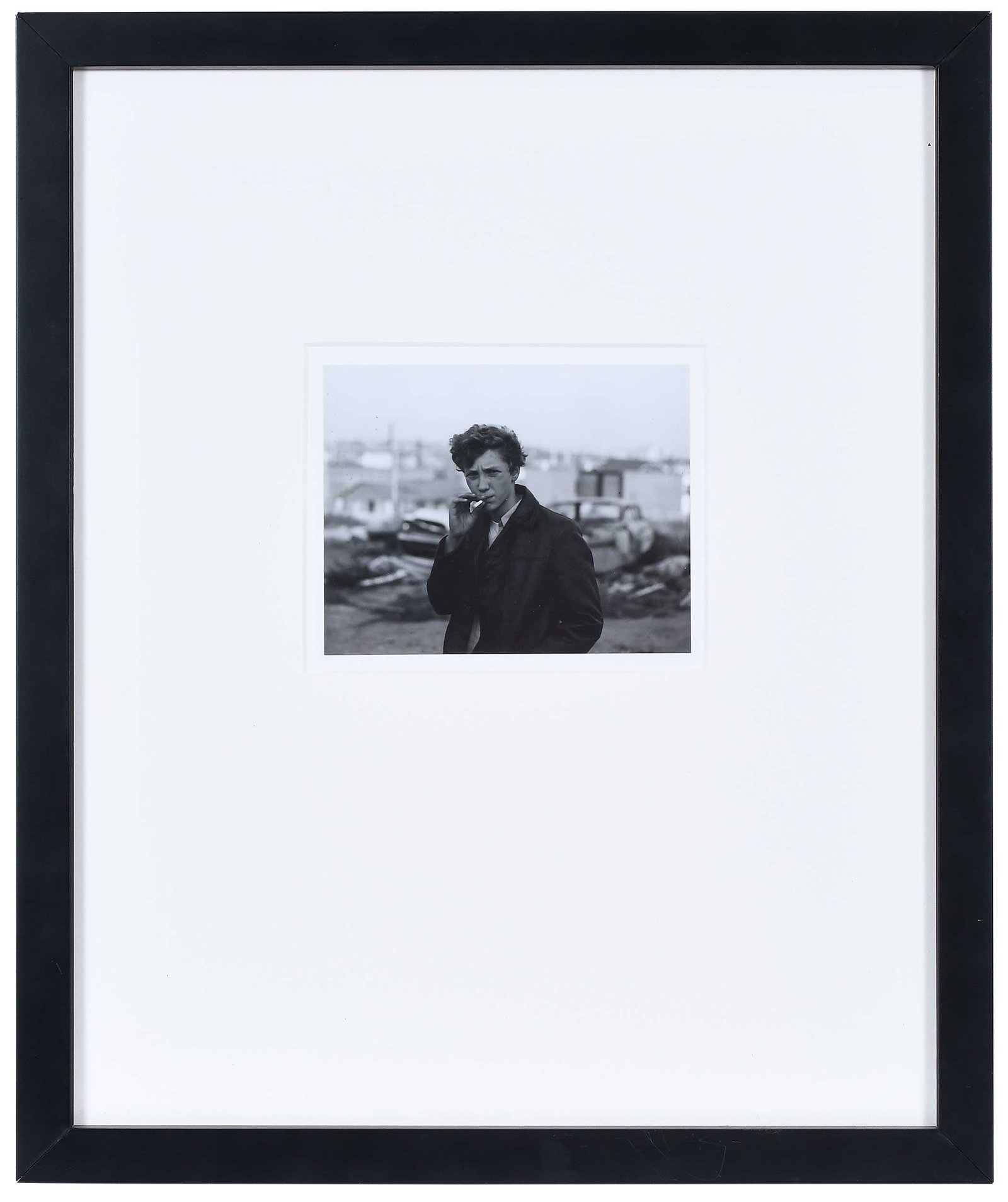 Julius Neelley: (American, born 1946) Boy Smoking, circa 1969, vintage gelatin silver print from the Rhode Island School of Design Portfolio, printed in 1969, #24 embossed on mount, 4-1/2 x 5-3/4 in.; black finished 