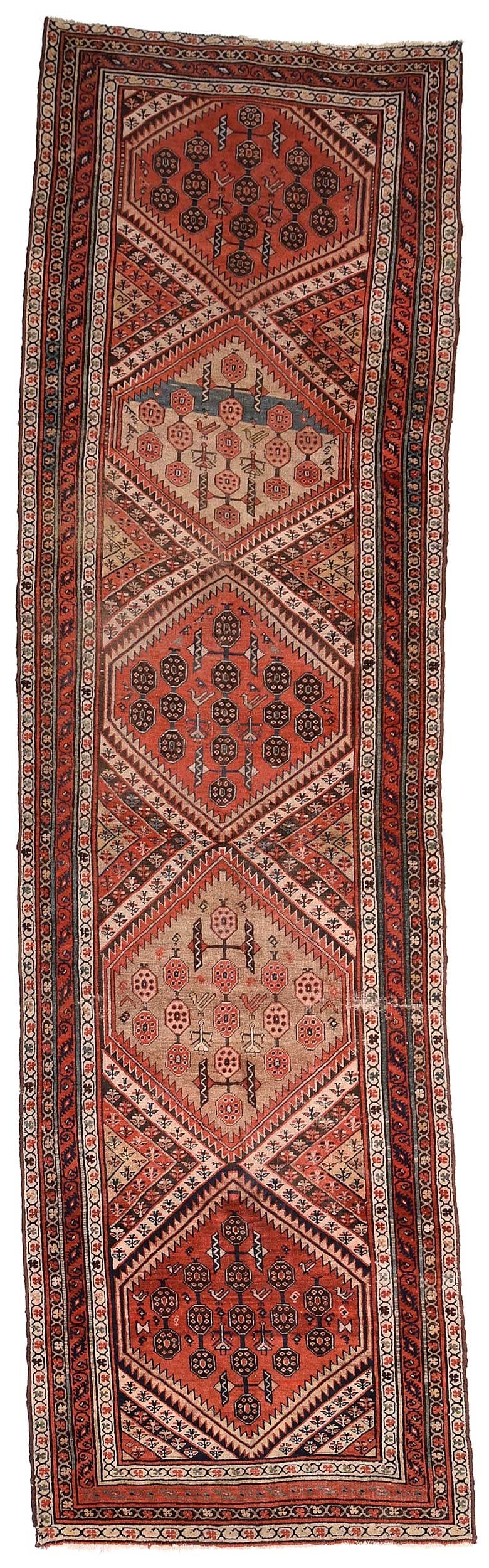 Persian Runner: five serrated central medallions flanked by similar half diamonds, birds and skirted human figures, multiple floral borders, 3 ft. 6 in. x 12 ft. 1 in. Provenance: Private Collection, Asheville, North