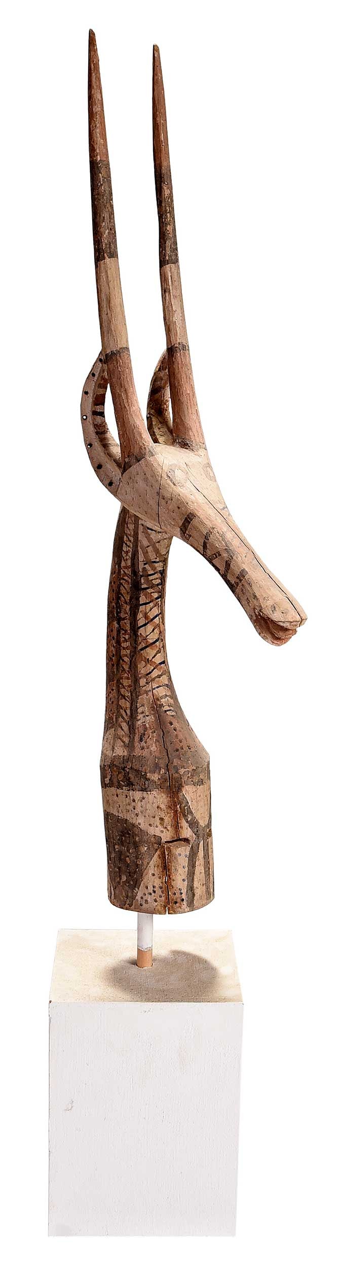 Bambara Antelope Dance Headdress: Mali, early 20th century, wood with red, black, and cream pigment, on a modern wood base, headdress 39-1/2 x 5 x 4-1/2 in., with base 59-1/2 x 9 x 9 in. Provenance: Work Wonders, San F