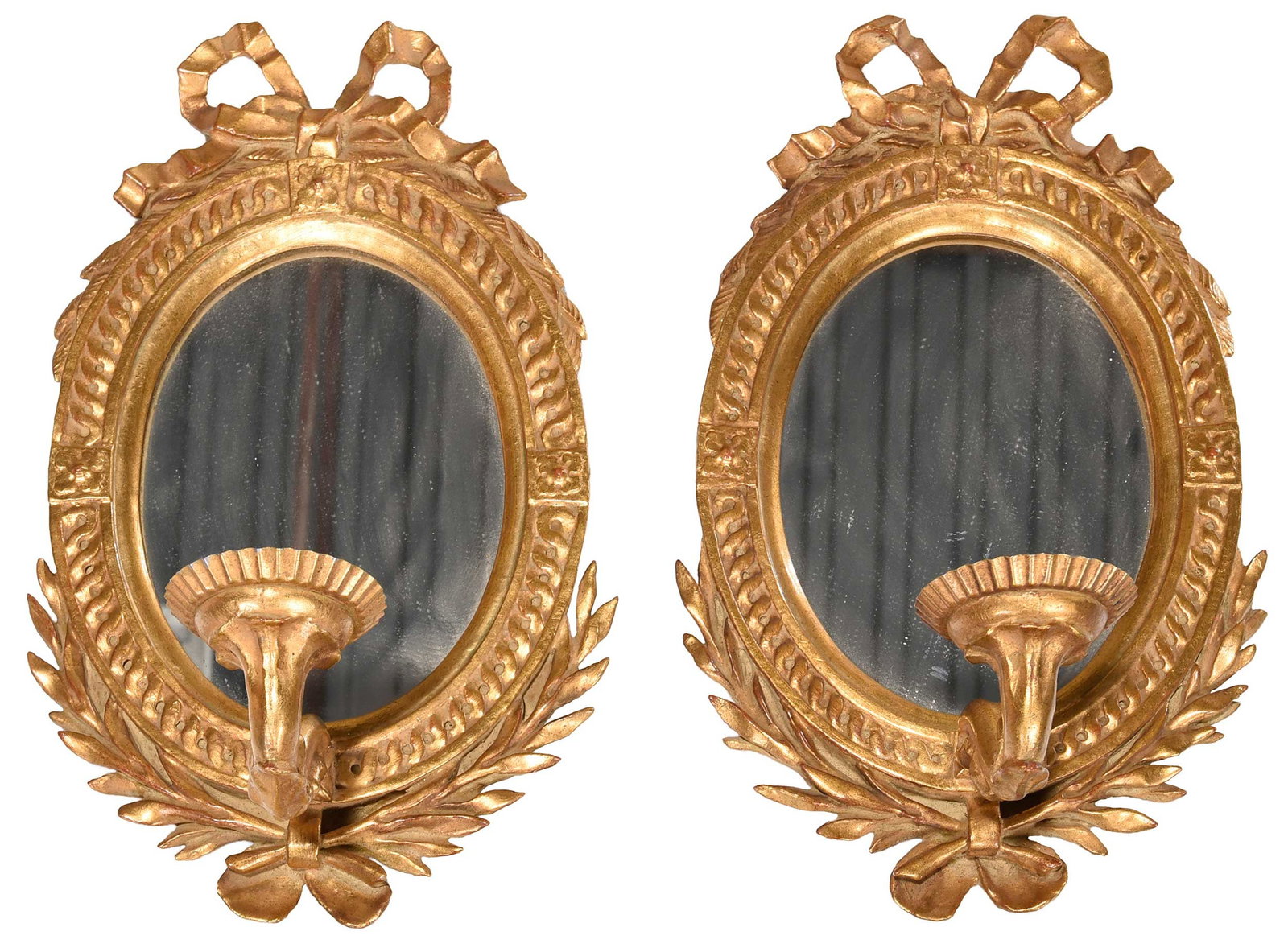 Pair of Neoclassical Style Ribbon Tied Mirrored Sconces: 20th century, oval plate surrounded by geometric border surmounted with ribbon tied decoration, each issuing a single scrolled candle arm, 17-1/8 x 10-1/4 in.