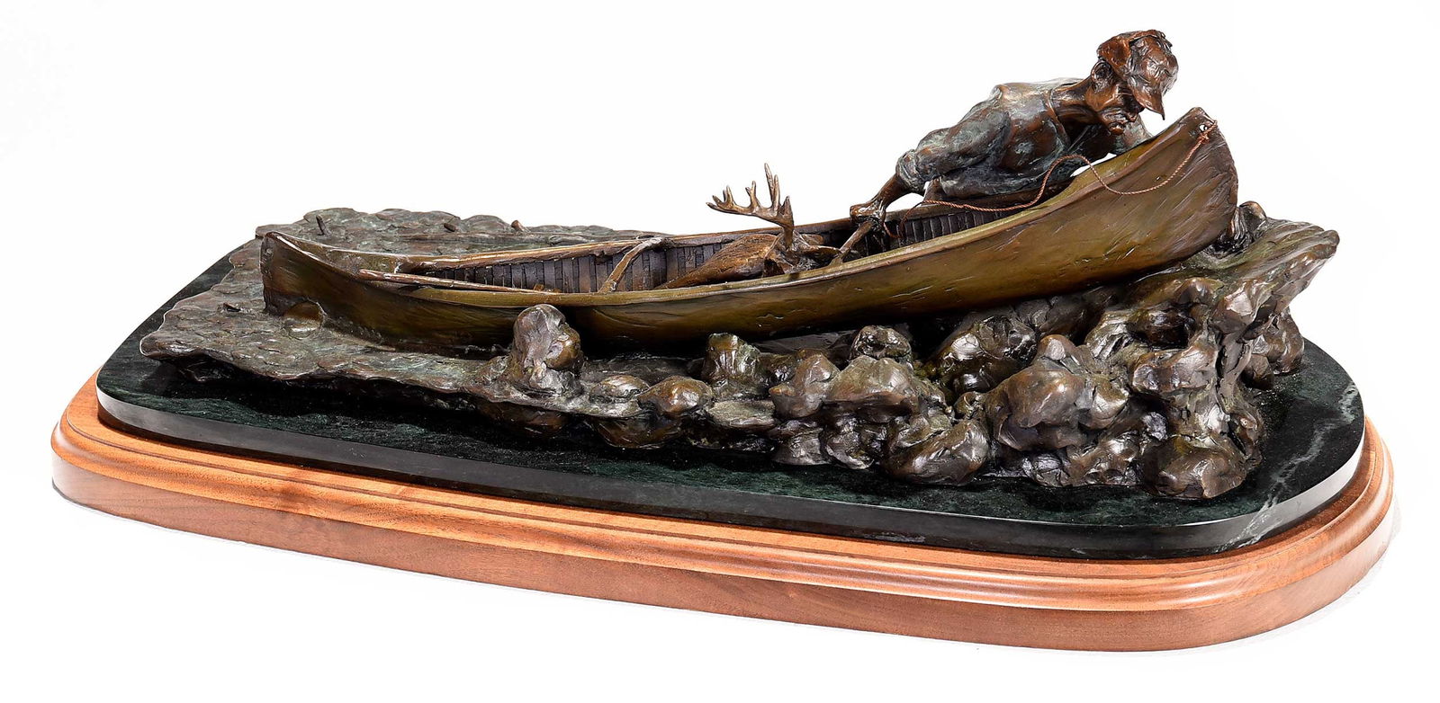 Sporting Bronze, Hunter with Canoe: (American, 20th/21st century) A hunter running his canoe ashore loaded with ten point buck, signed indistinctly "M... Rey" (or Roy), patinated bronze on marble and wood plinths, overall 12 x 29 x 14 i