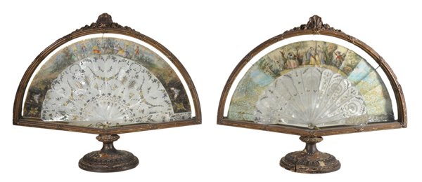 Two Continental Cased Hand-Painted: Fans 19th century, finely carved and cut-out mother-of-pearl staves, gilt-decorated and hand-painted arched tops decorated with figures in exterior landscapes, winged [putti] and classical maidens on 