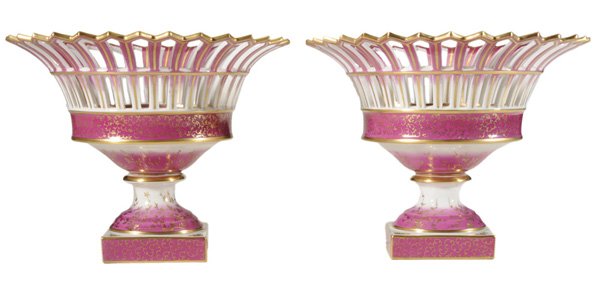 Pair Berlin Porcelain Center Bowls: German, late 19th/early 20th century, reticulated borders, raspberry-colored decoration with extensive gilt highlights, raised on pedestals with square plinths, blue scepter mark under glaze, 7-3/4 in