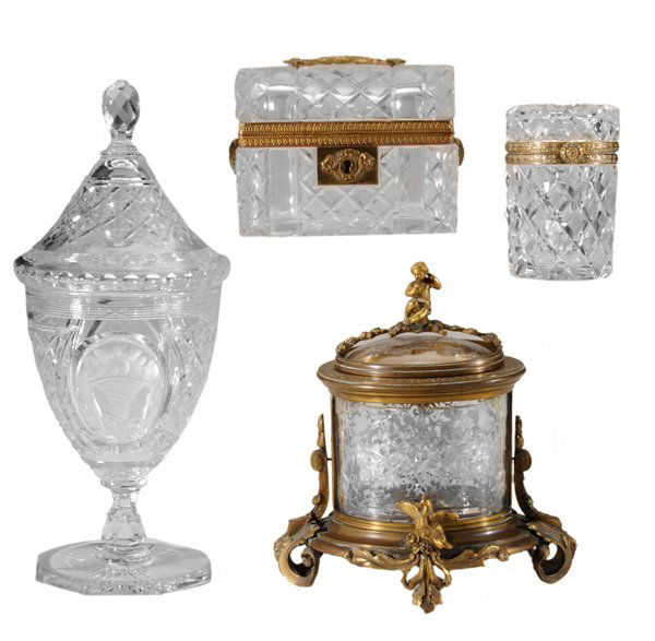 Four Pieces Decorative Glassware: French, 19th/20th century: brass-mounted lidded box with cut decoration, 5-1/2 in.; cylindrical dresser box with brass mounts, 4-1/4 in.; cut and intaglio lidded urn, 12-1/4 in.; clear lidded oval box