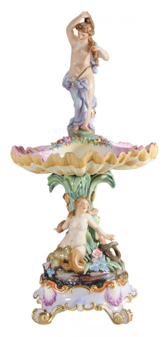 Capodimonte Figural Center Bowl: Continental, 20th century, woman with blue drapery above sectional shell-shaped central plate over base with scrolled feet, mermaid and merman, blue crown-over-N mark under glaze, 20-1/2 in., one scro