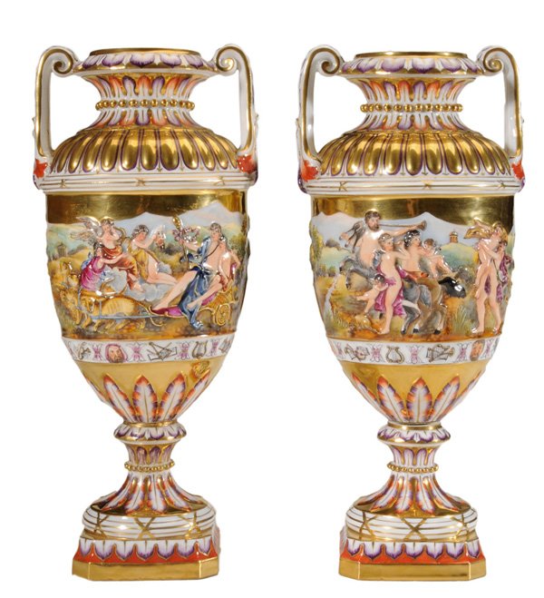 Pair Capodimonte Urns: Continental, late 19th/early 20th century, broad band of raised decoration, one side with classical figures and angels in chariot pulled by four large cats, other side with centaur and figures in fest