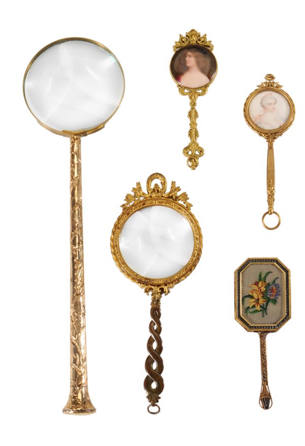 Five Hand Mirrors, Magnifying Glasses: Continental, late 19th/early 20th century: gold-plated long-handled magnifying glass, 14-1/2 in.; French gilt bronze magnifying glass, 8-7/8 in., [replaced handle;] three ladies' gilt metal hand mirro