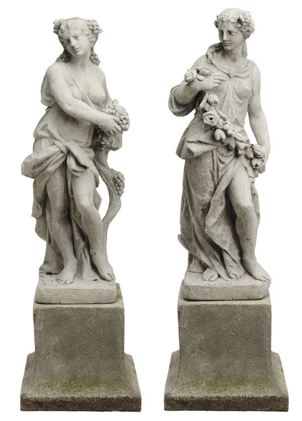 Two Cast Stone Garden Statues: 20th century, classical figures of women, one holding grapes, one holding a garland of flowers, concrete or cast stone, on later concrete plinth, 61 in., surface wear and weathering throughout, otherw
