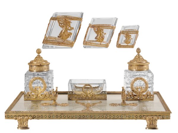 Gilt Bronze Clear Crystal Desk Set: probably French, late 19th/early 20th century, consisting of a gilt bronze rectangular plateau holding an ink stand, pin tray and pen holder, raised on a footed base; with three pieces of similar desi