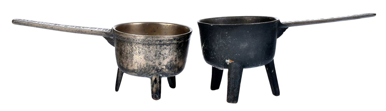 Two Impressed Leaded Bronze Posnet Pots Dated 1684: British, each tripod basin with tapered handle with impressed slogan "PITTY THE PORE 1684", larger 6 x 14-1/2 x 6 in. Provenance: Collection of John B. and Marie-Teresa Vander Sande, Newbury, Massachu