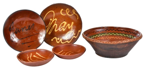 Four Pennsylvania Slip Decorated Redware Plates and a Milk Bowl