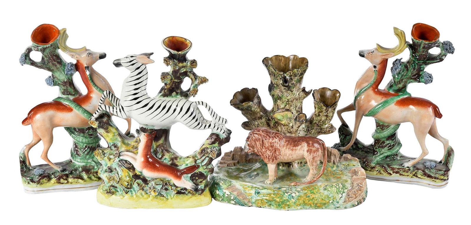 Four Staffordshire Jungle Animal Spill Vases: British, 19th century, comprising: near pair featuring antelope entwined by snake, 10-3/4 x 7-1/4 x 2-5/8 in.; spill vase with zebra and fox, 10-1/4 x 8-3/4 x 2-3/4 in.; vase with lion in naturalistic