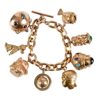 14kt. Large Charm Link Bracelet: eight rose gold links, alternating with nine textured yellow gold links, toggle closure, unstamped, bracelet tests 14kt., eight suspended charms comprising: fish carnelian cabochon eyes, unstamped, te