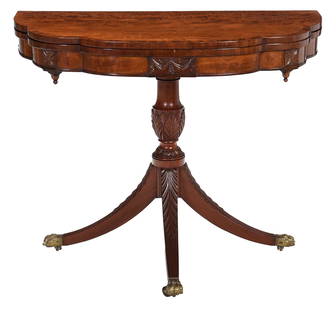Classical Carved and Figured Mahogany 'Trick-Leg' Games Table with Carved Rosettes: New York, circa 1815, attributed to Michael Allison (1773-1855), brass paw form casters, retains remnant of repair label of Ernest Hagen, 30-1/4 x 33-3/4 x 17-3/4 in., opens to 35-1/2 in. Provenance: