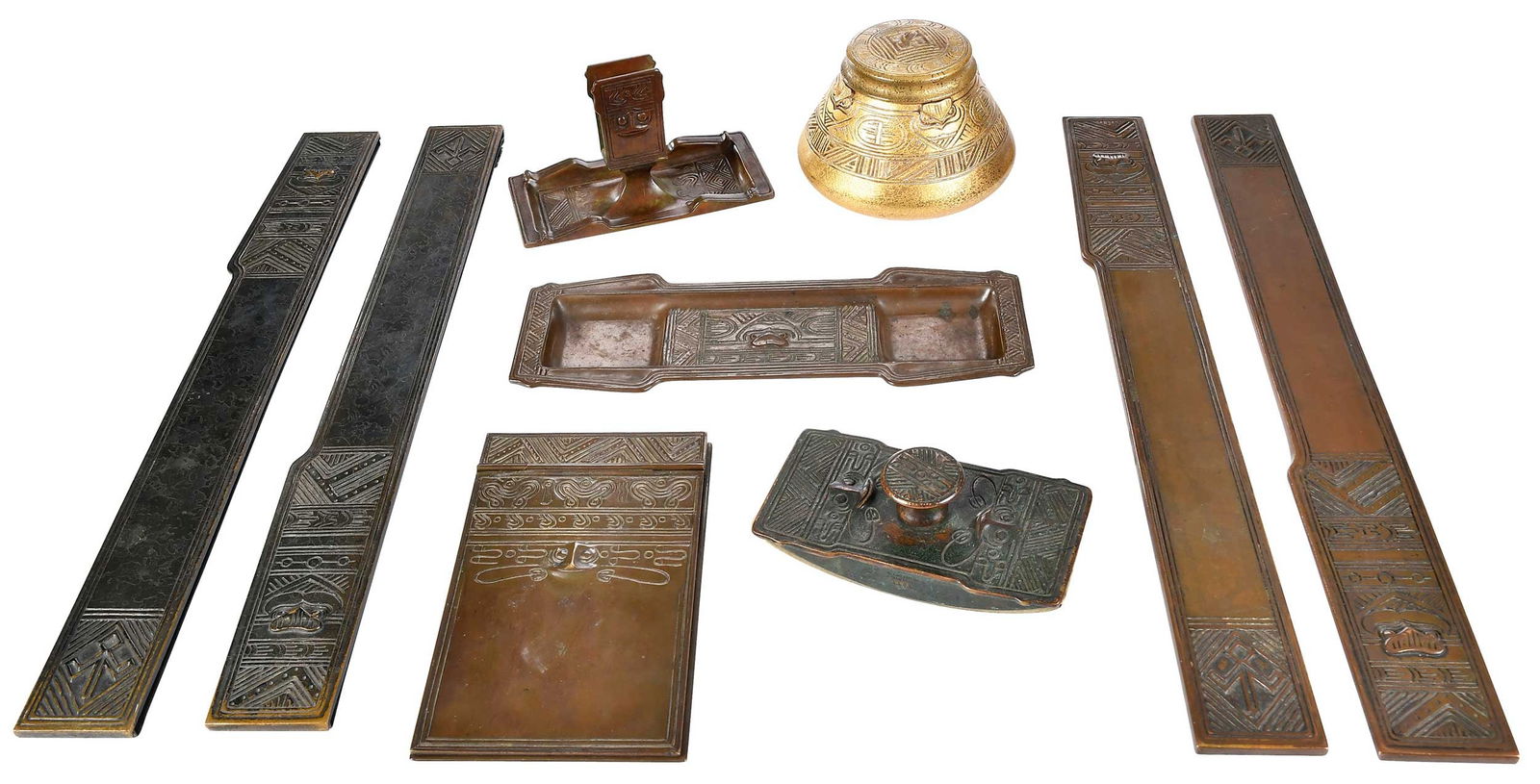 Tiffany Studios American Indian Bronze Seven Piece Desk Set: American, late 19th/early 20th century, with Tiffany Studios marks, comprising: ink blotter, two pairs of blotter ends, notepad holder, pen tray, ashtray/matchbox holder, and inkwell, largest 3-3/4 x